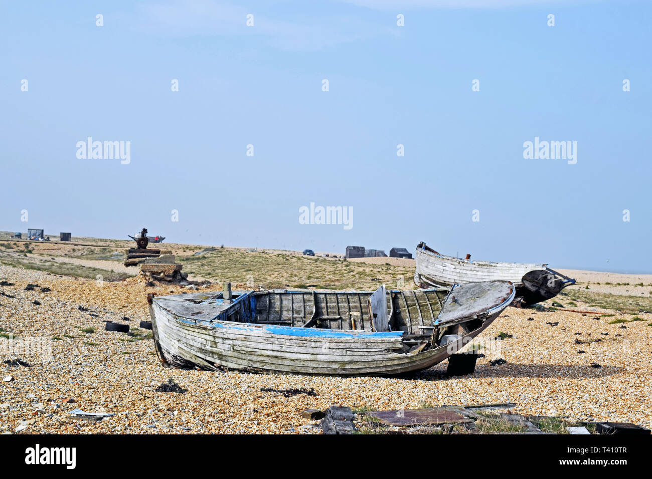 A close up of an abandoned old fishing boat on the pebble beach at ...