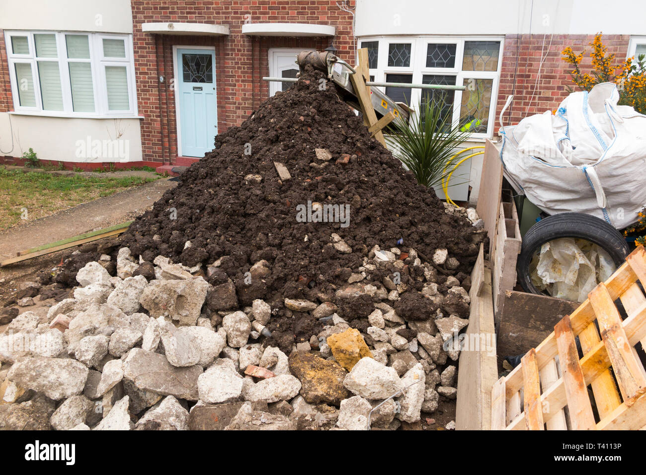 Machine / conveyor belt removing soil debris and spoil waste from house
