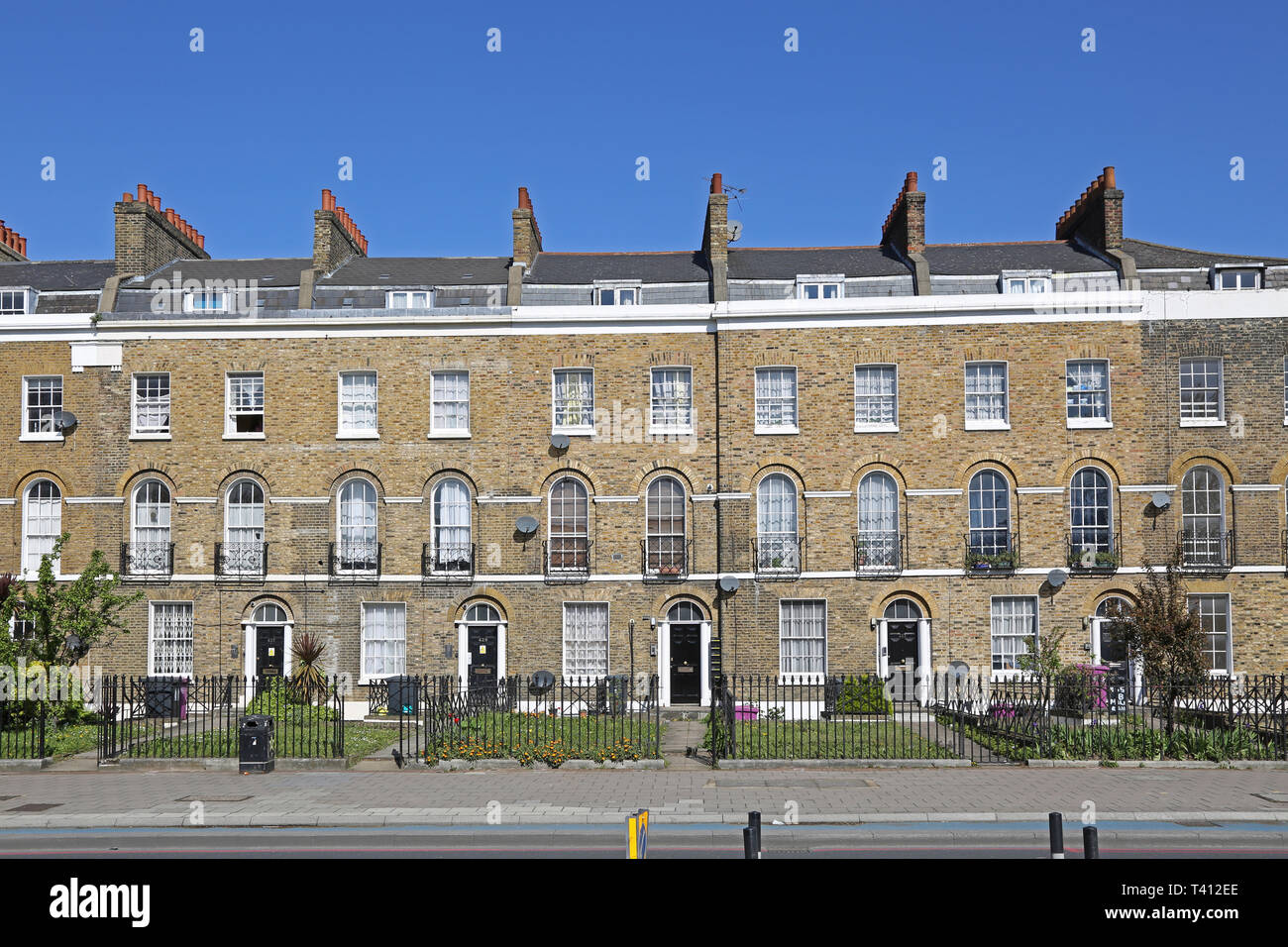 Elegant terrace of Georgian houses on Bow Road in London's East End, UK. Corner of Tredegar Square. Most now converted to flats. Stock Photo