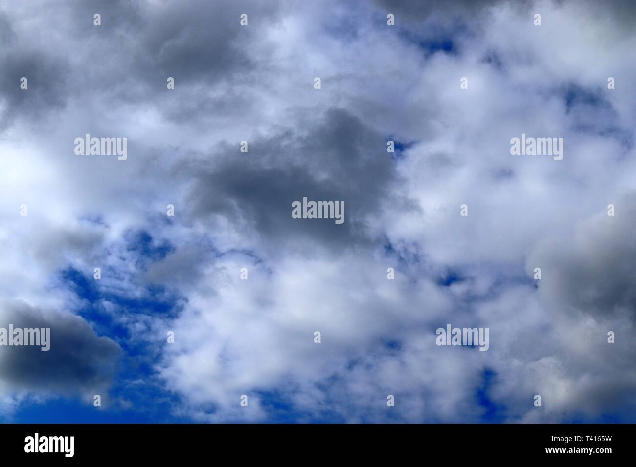 Beautiful fluffy white cumulus and cirrus clouds on a deep blue sky ...