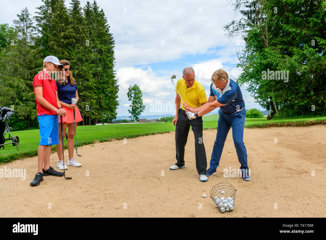 Golf group training lesson in sandbunker Stock Photo