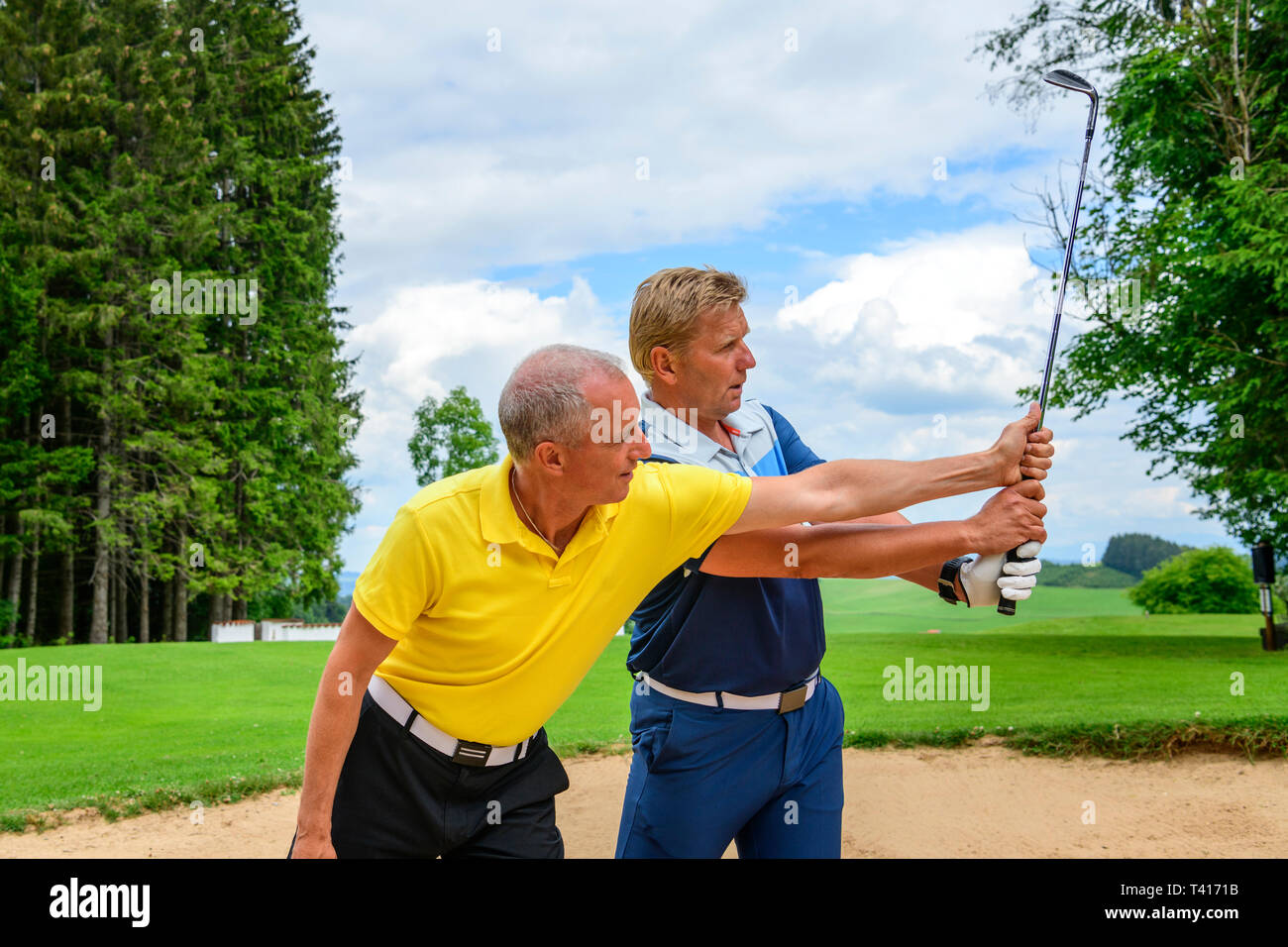 Golf training lesson in sandbunker Stock Photo