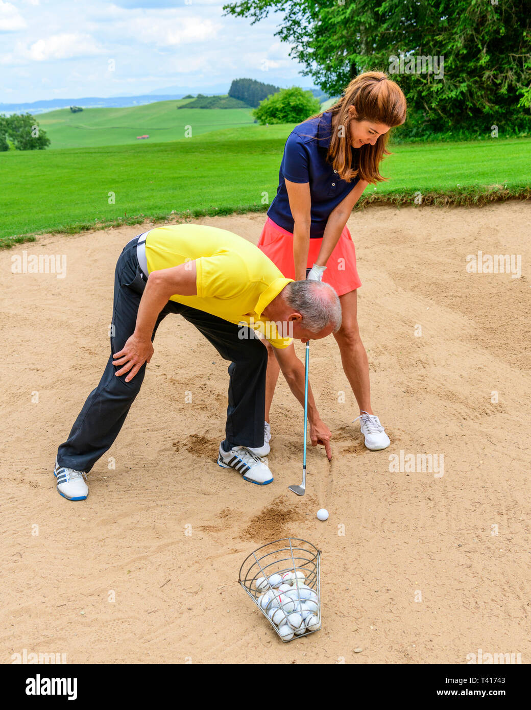 Golf training lesson with pro in sandbunker Stock Photo