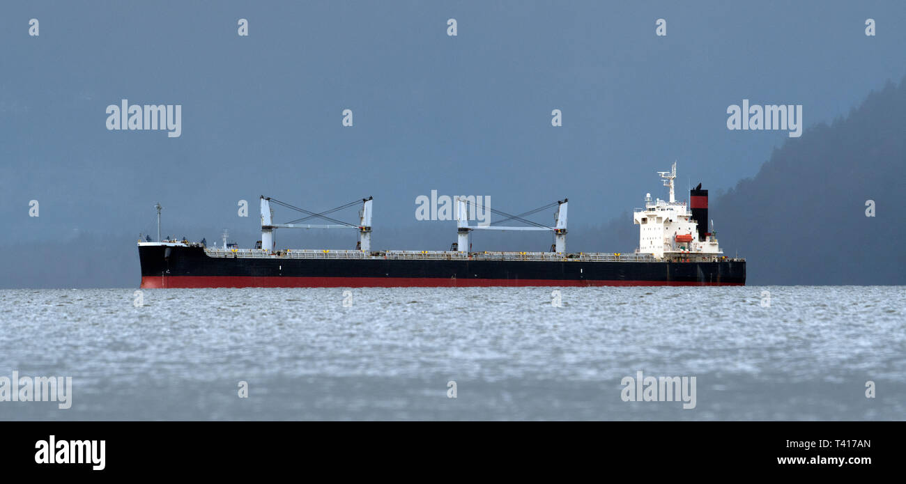 Cargo ship near the coast, British Columbia, Canada Stock Photo
