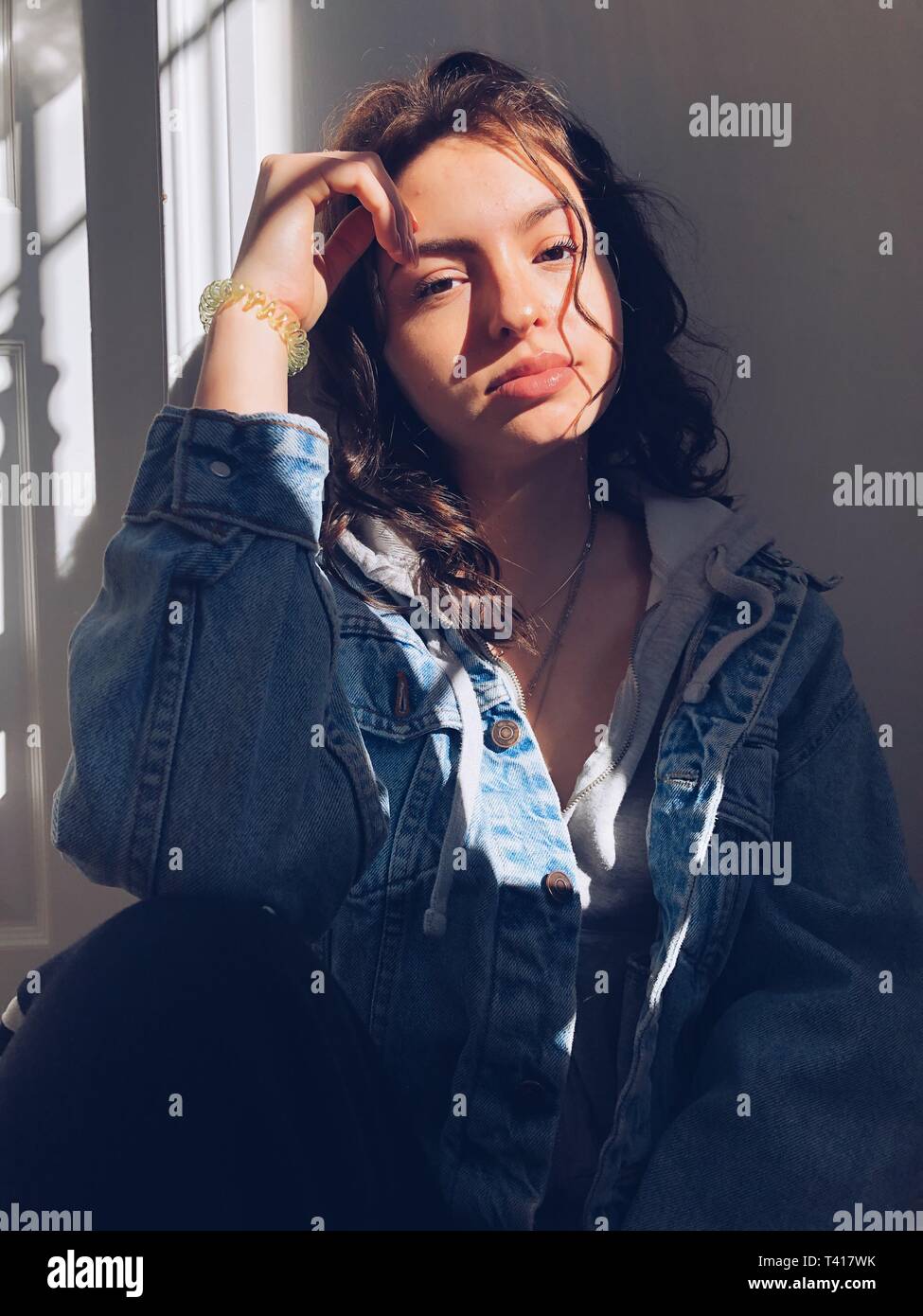 Portrait of a teenage girl with her hand on her face Stock Photo