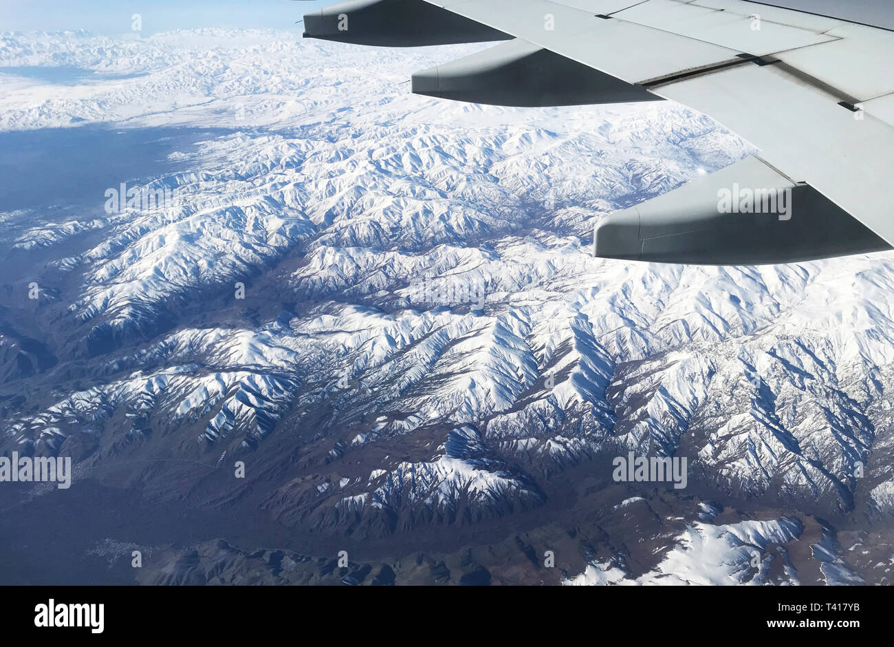Snowcapped mountains and aircraft wing, Azerbaijan Stock Photo