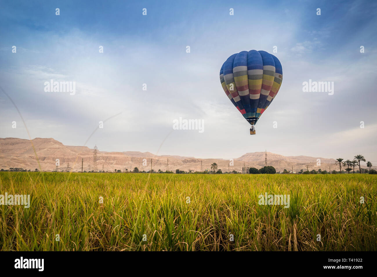 Hot air balloon flying over Valley of the Kings, Luxor, Egypt Stock Photo