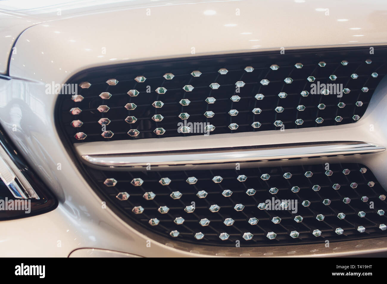 Close up of luxury sports car front grill. Grid of car radiator metal