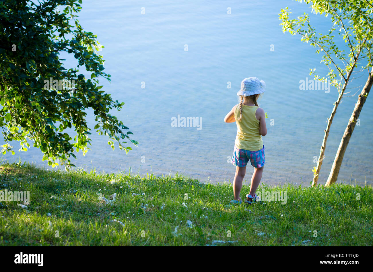 Girl standing alone in green hi-res stock photography and images - Alamy