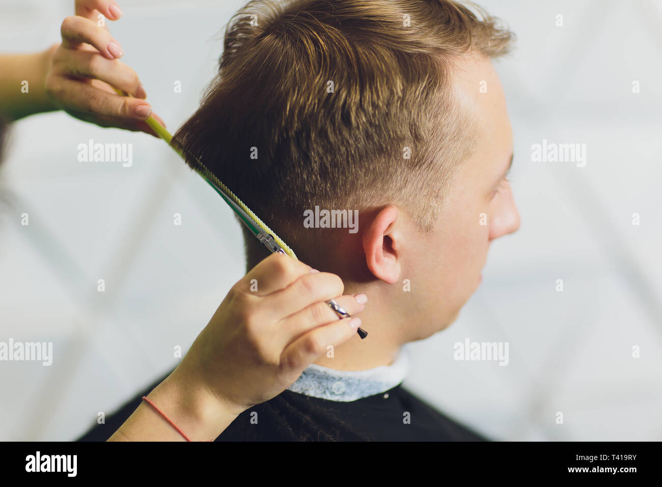 cutting mans hair with scissors