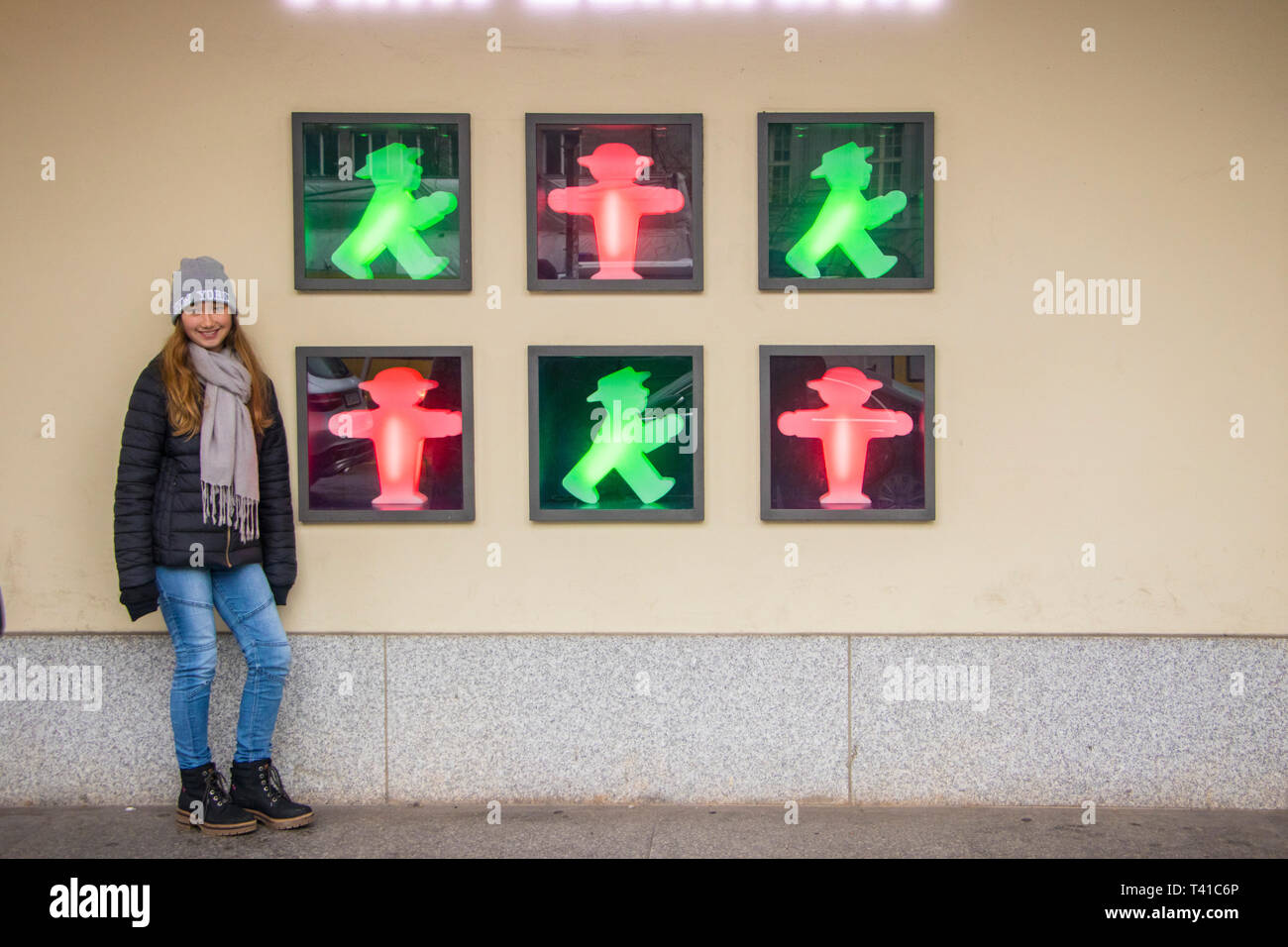 young girl poses by famous Ampelmännchen pedestrian crossing symbols Stock Photo