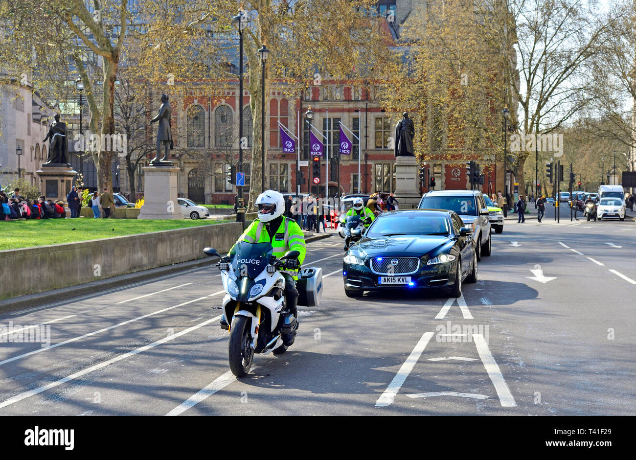London, England, UK. The Prime Minister's cars and motorcylce outriders driving through Parliament Square Stock Photo