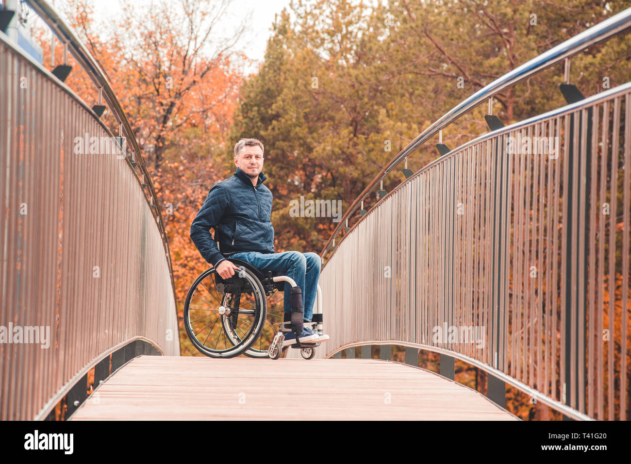 Man in a wheelchair use a wheelchair ramp Stock Photo - Alamy