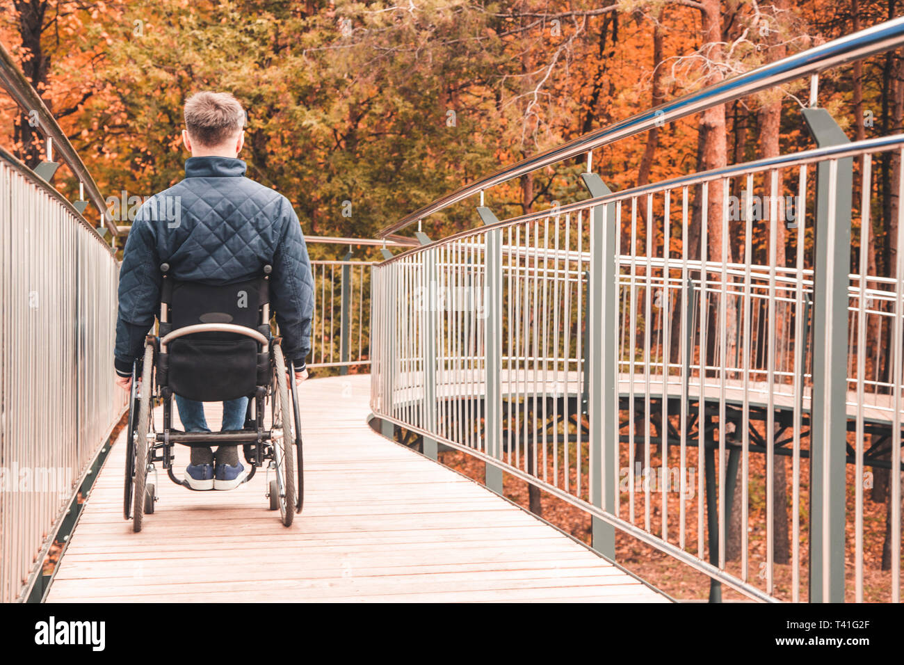 Man in a wheelchair use a wheelchair ramp Stock Photo - Alamy