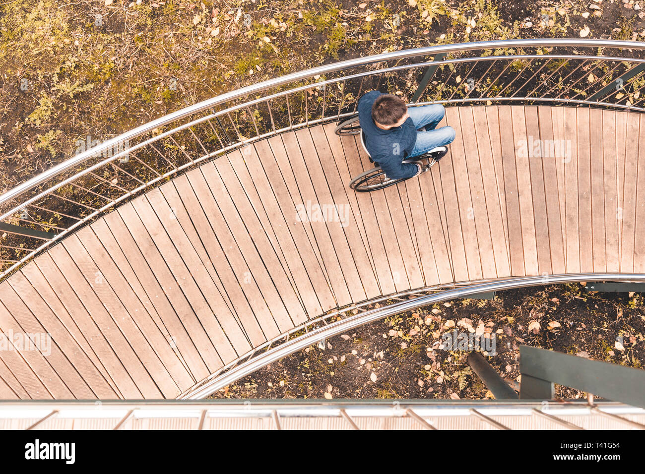 Man in a wheelchair use a wheelchair ramp Stock Photo - Alamy