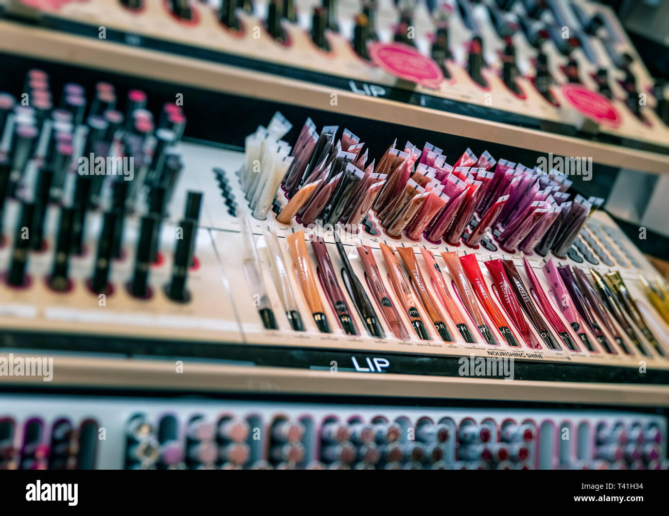 Lip gloss display in a Sephora personal care and beauty store. Stock Photo