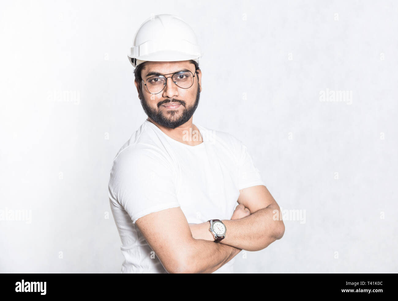 Young builder engineer with glasses and a white protective helmet Stock Photo