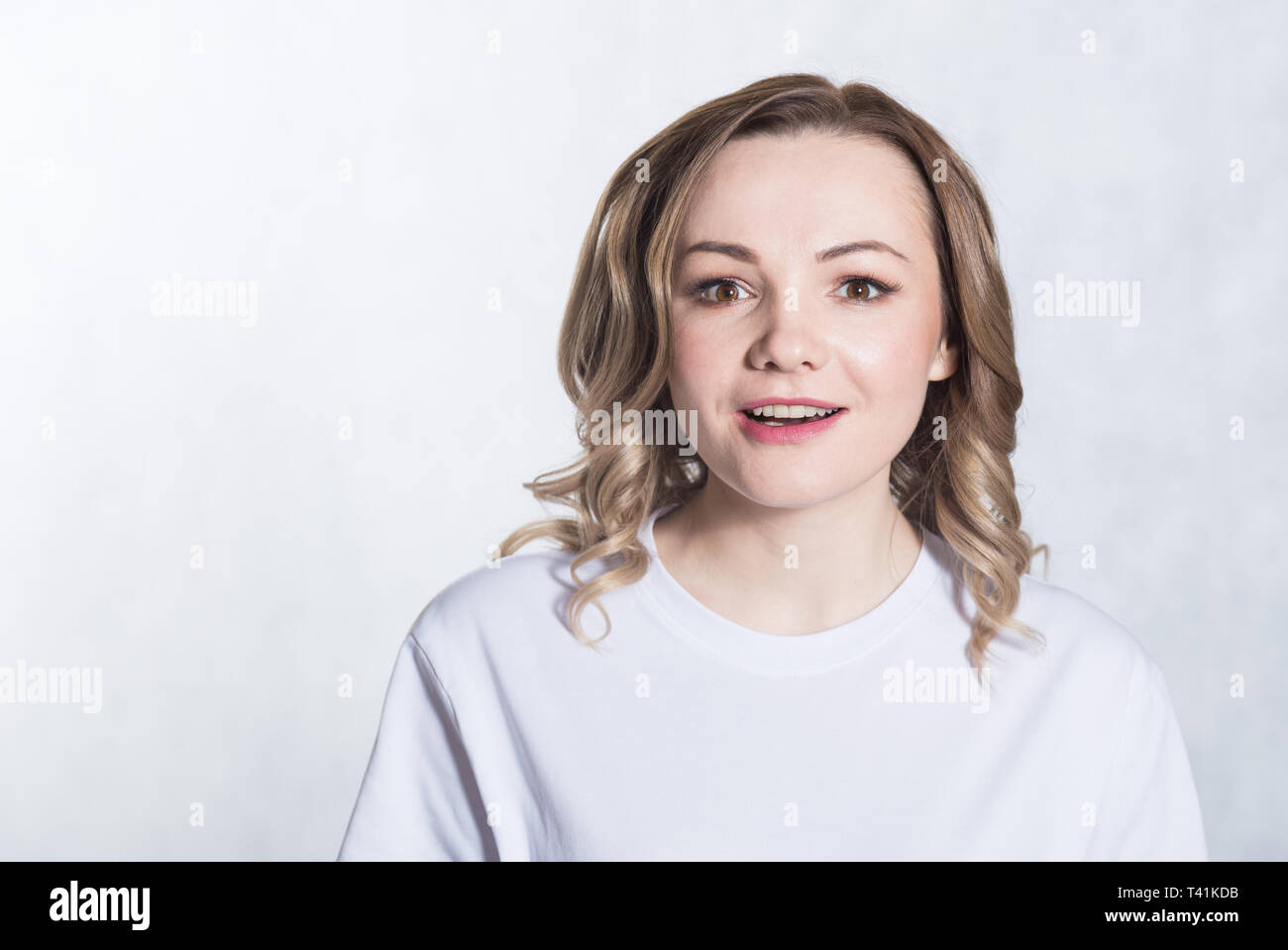 Portrait of a young surprised woman on white background Stock Photo - Alamy