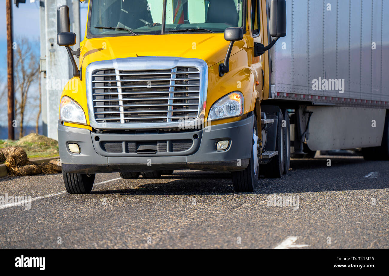 Front view of Yellow day cab professional reliable freight
