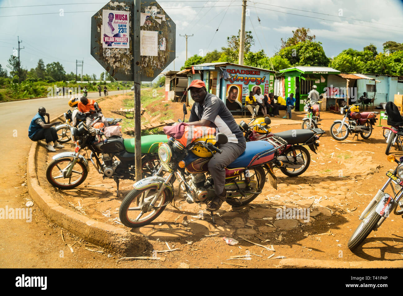 near Kisumu, Kenya - March 8, 2019 - Local Kenyan people near a small shop on the road Stock Photo