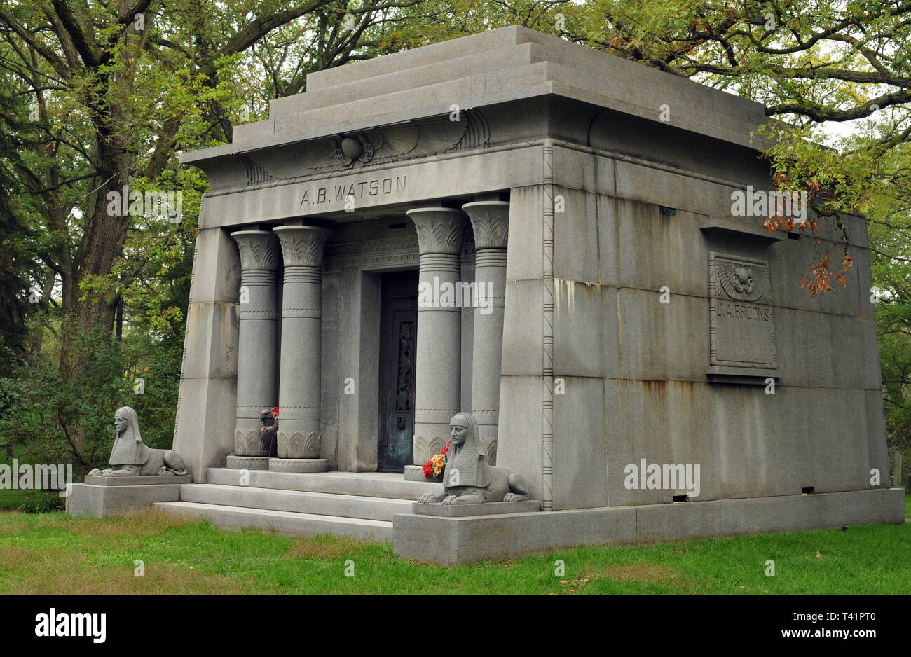 An Egyptian Revival temple mausoleum guarded by sphinx sculptures marks