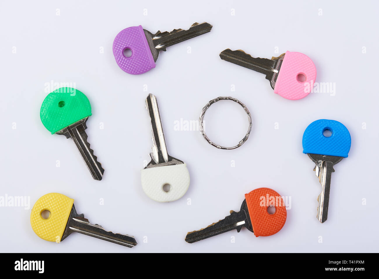 Metal colorful keys background. Different color key lay on white background Stock Photo