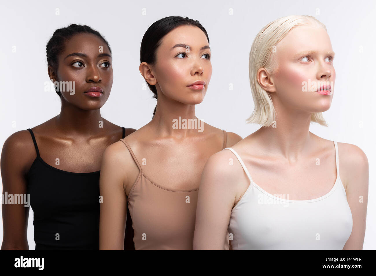 Wearing camisoles. Three young good-looking women with different skin color  wearing camisoles Stock Photo - Alamy