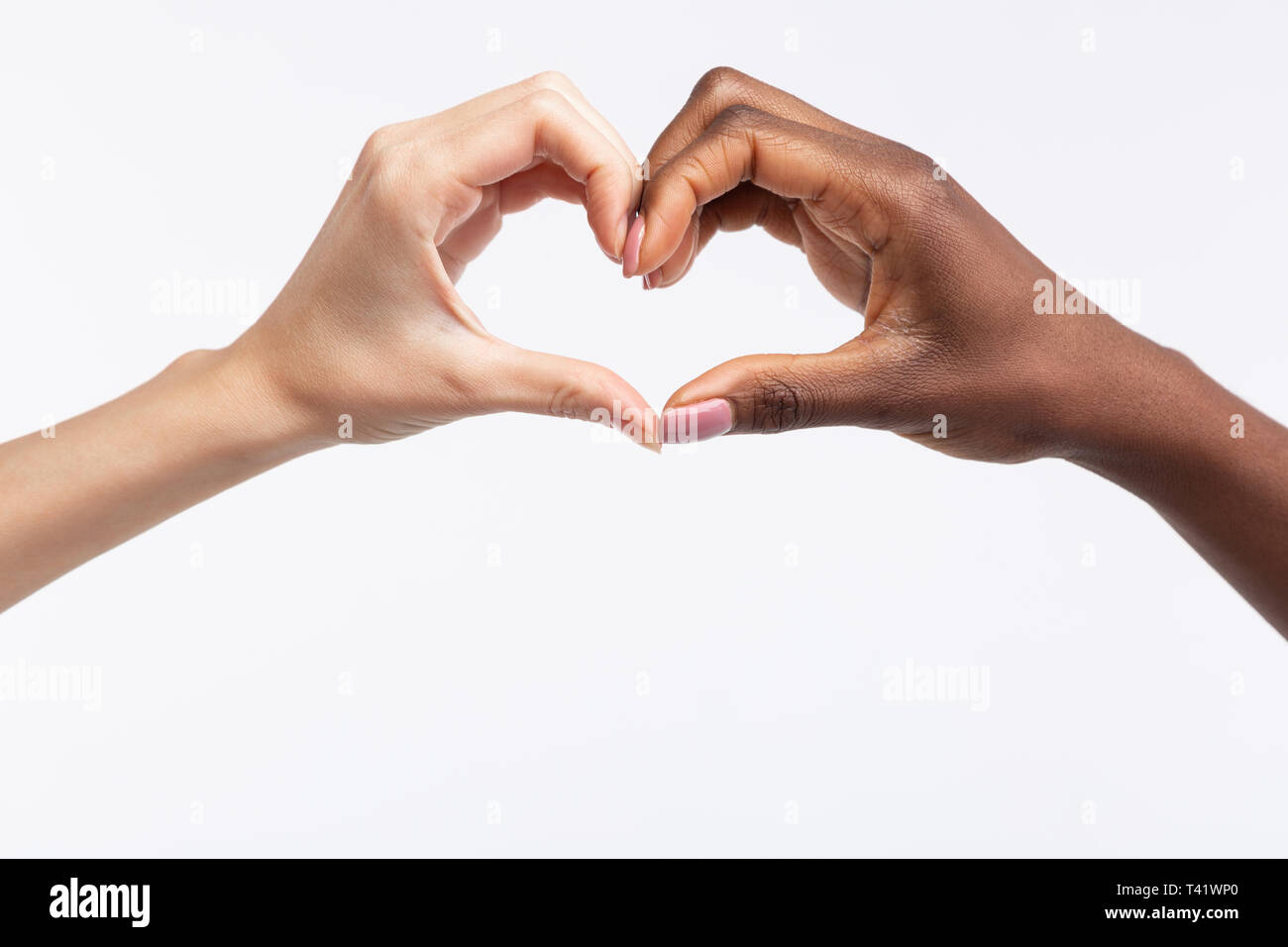 Women with different skin color making heart out of hands Stock Photo