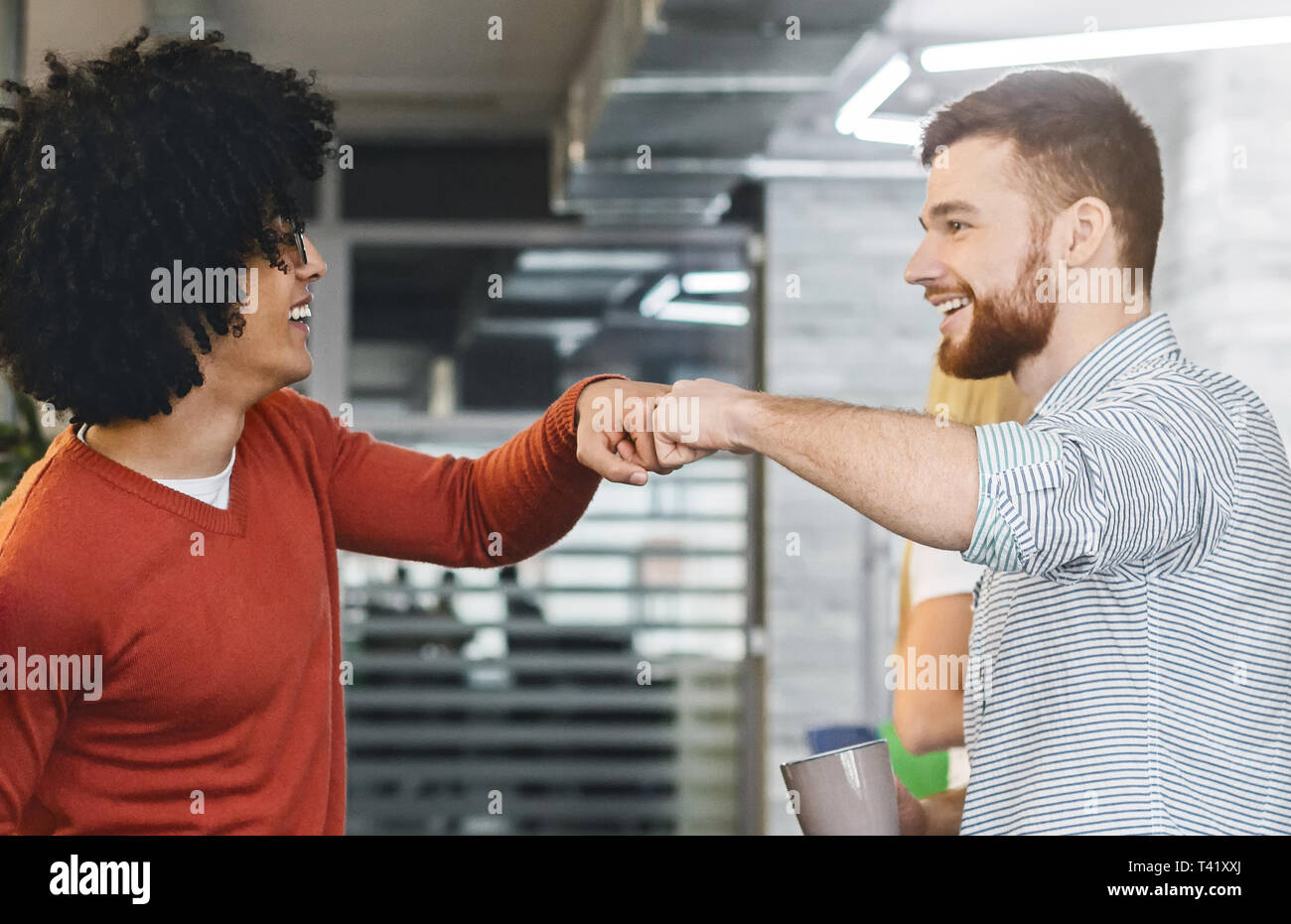 Friendly men coworkers having agreement, givint fist bump Stock Photo