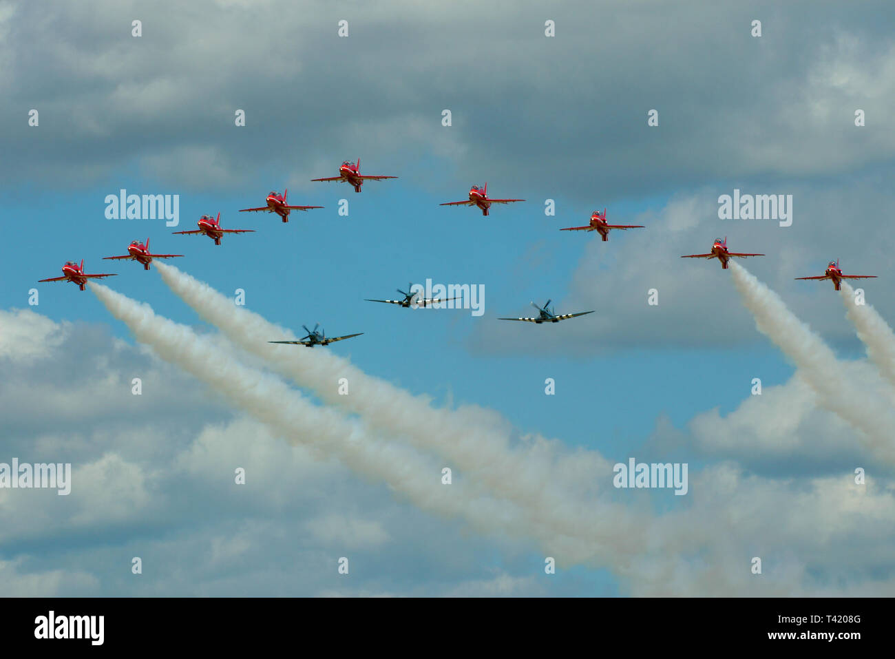 RAF Spitfires with Red Arrows Hawk T1 jet planes flying at the Royal International Air Tattoo, UK. Photo reconnaissance tribute flypast Stock Photo