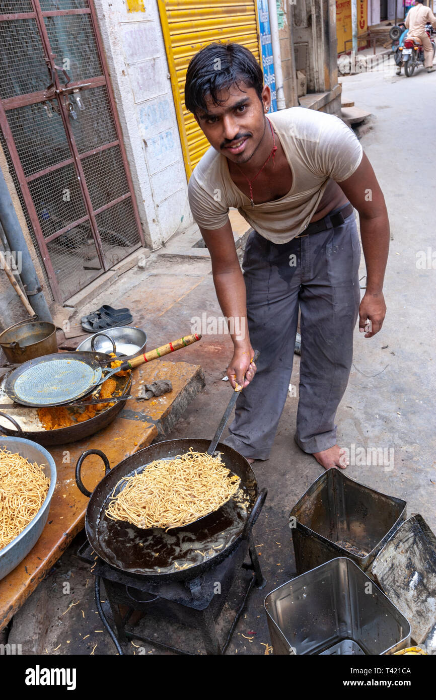 Man selling street fried food in Jaisalmer market, Rajasthan, India