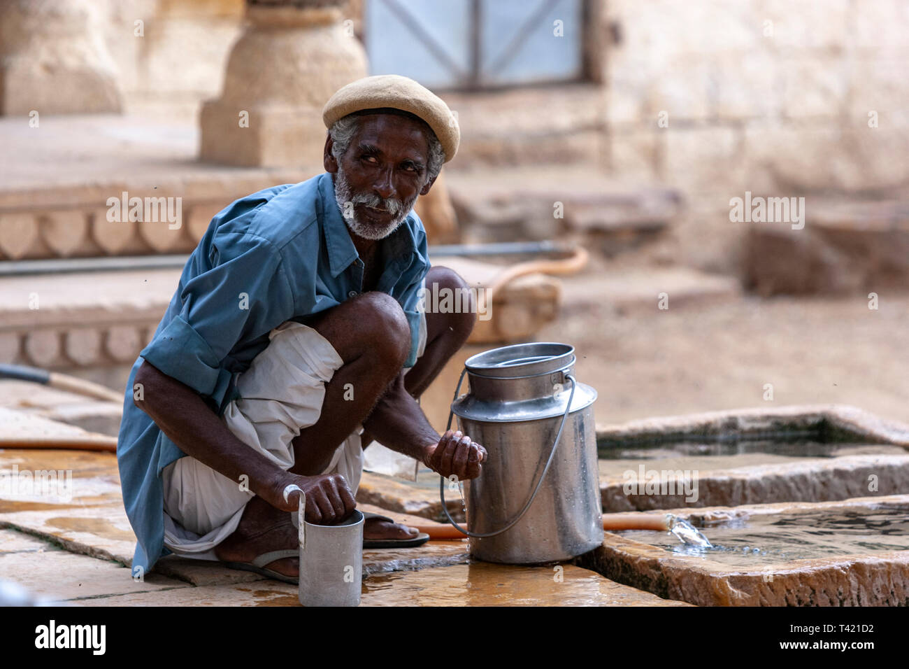 Man in charge of milk cows in Jaisalmer, Rajasthan, India Stock Photo