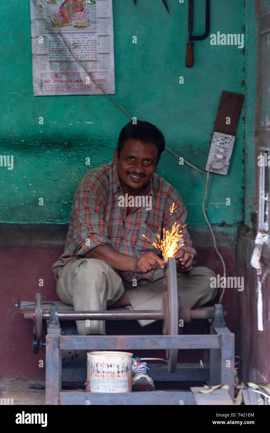 Man sharpen in a on abrasive cutting and knifesharpening stones in a