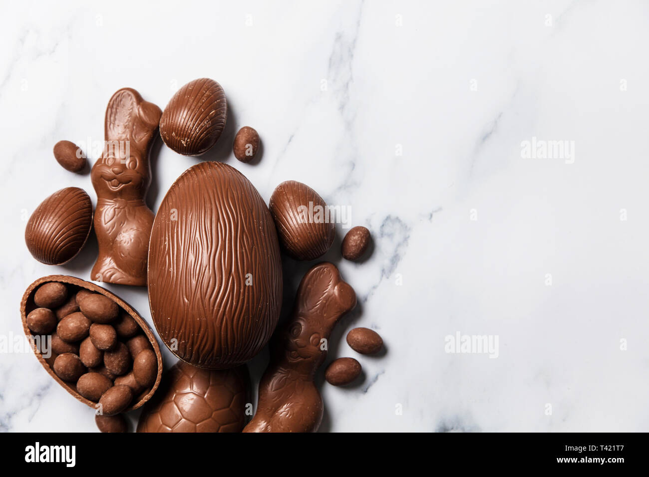 Chocolate easter eggs and bunnies on a marble background Stock Photo