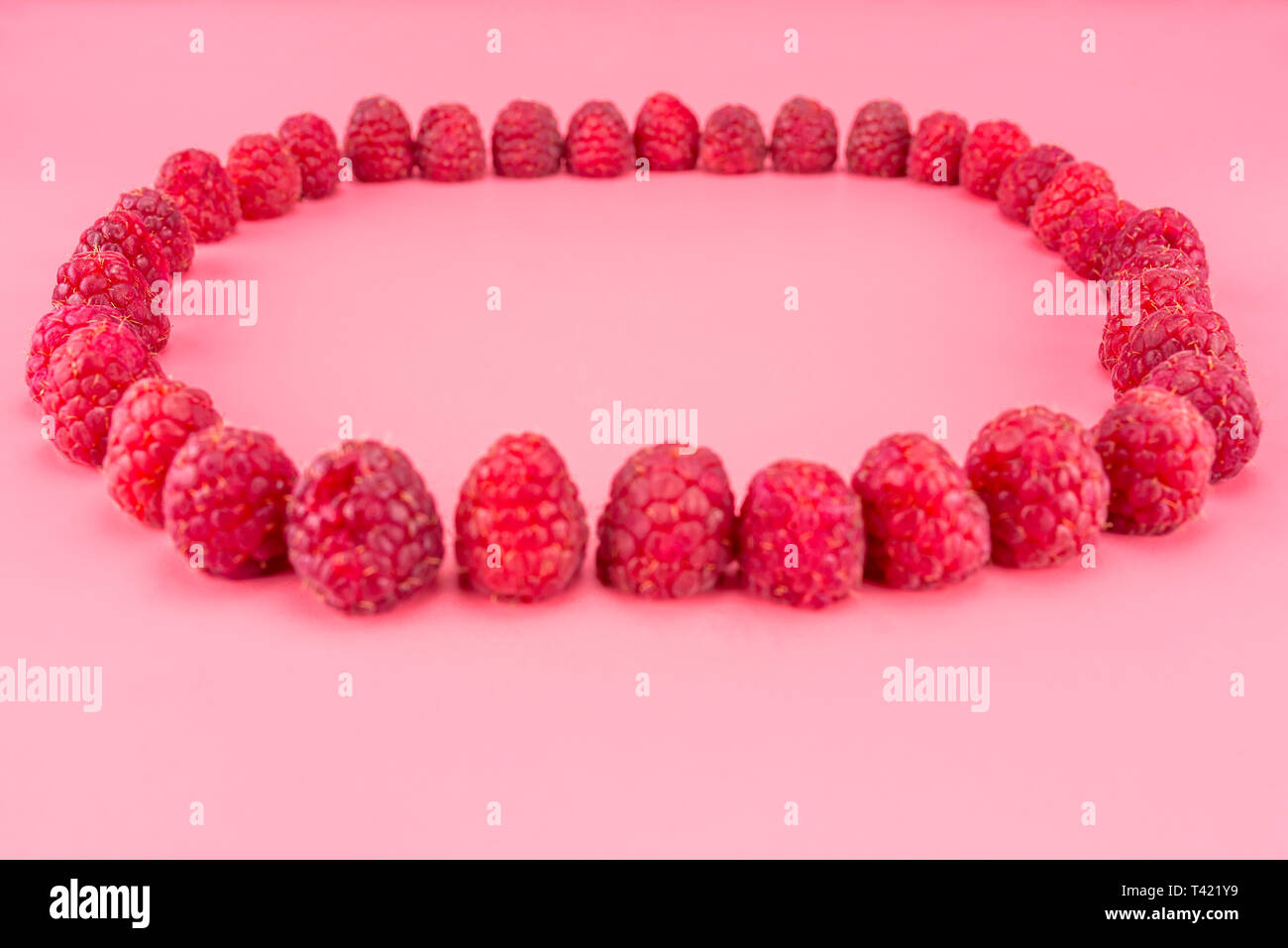 Raspberry Solid Shape Pattern made from fresh raspberries in the shape of a circle, view from ...