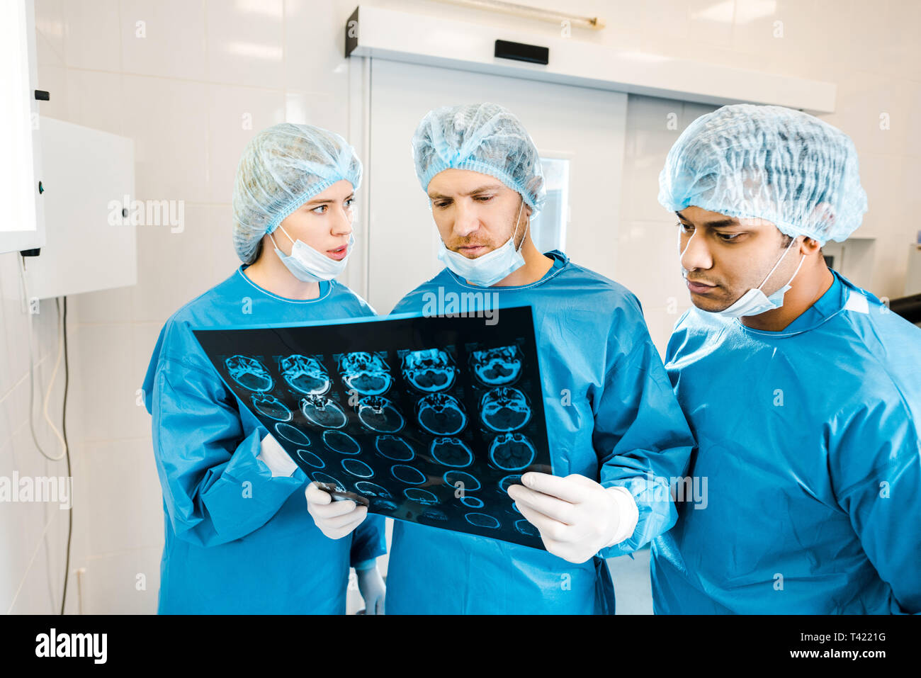handsome and beautiful doctors in uniforms and medical masks talking about xray Stock Photo Alamy