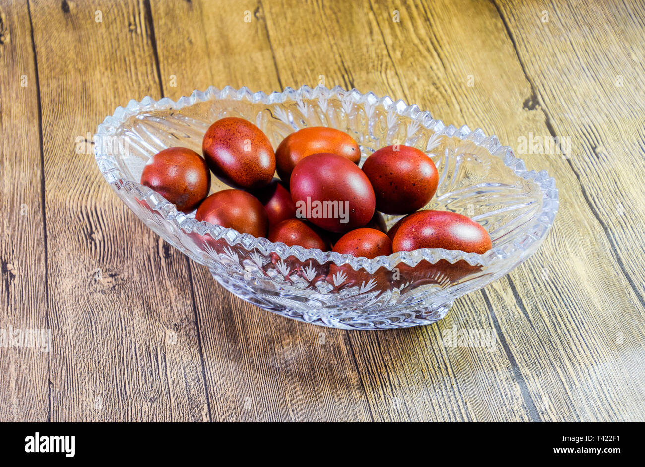 Painted Easter eggs in a crystal vase. Red painted chicken eggs for easter. Stock Photo
