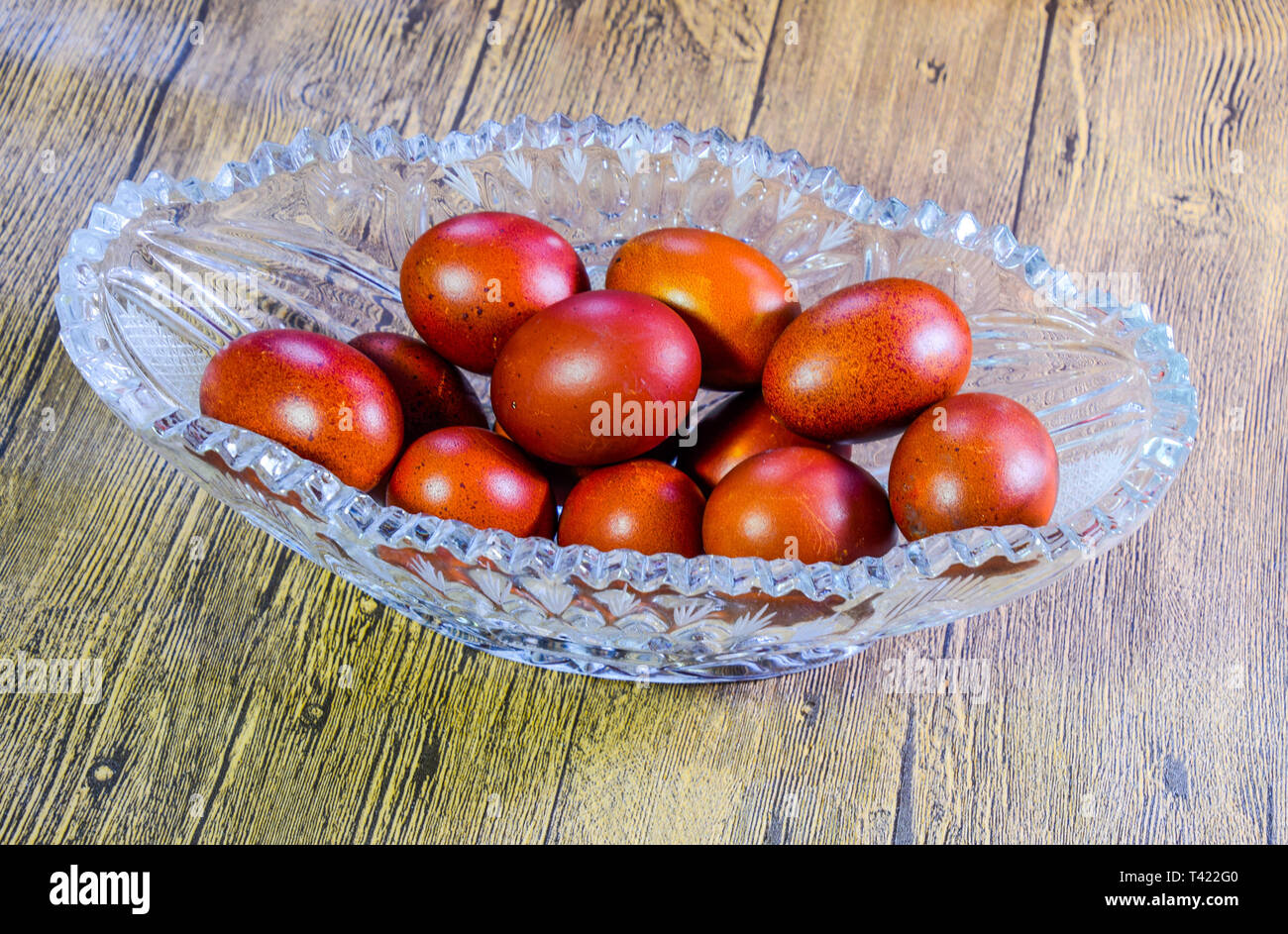Painted Easter eggs in a crystal vase. Red painted chicken eggs for easter. Stock Photo