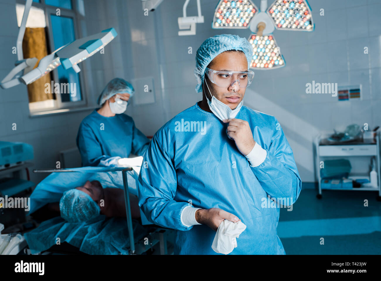 Putting off mask hi-res stock photography and images - Alamy