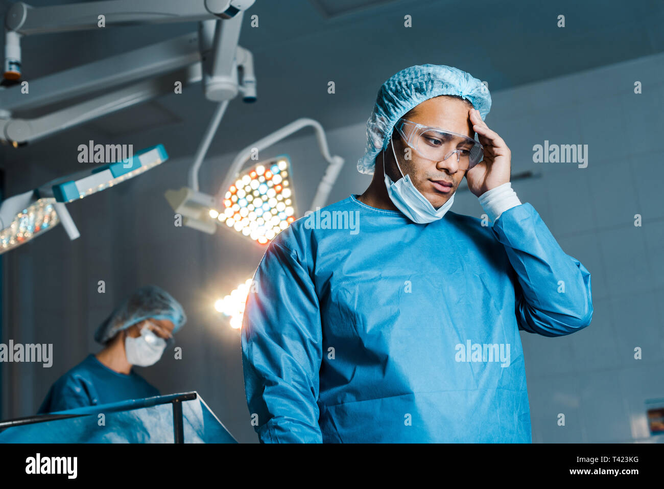 Operating room nurse looking down hi-res stock photography and images ...