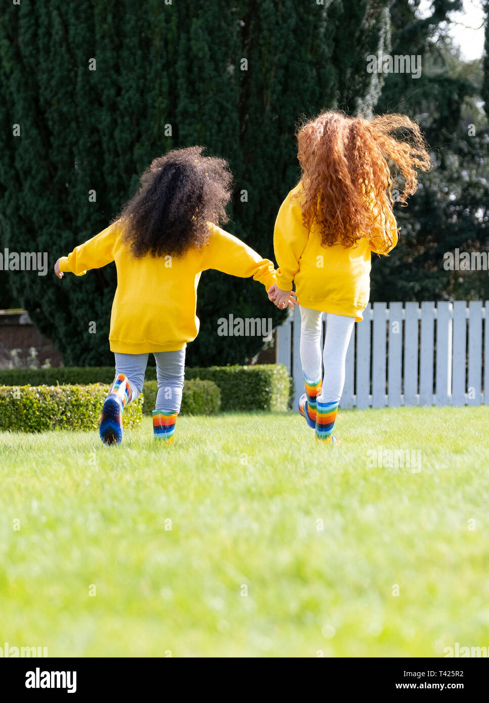 Children skipping enjoying playing outside Stock Photo