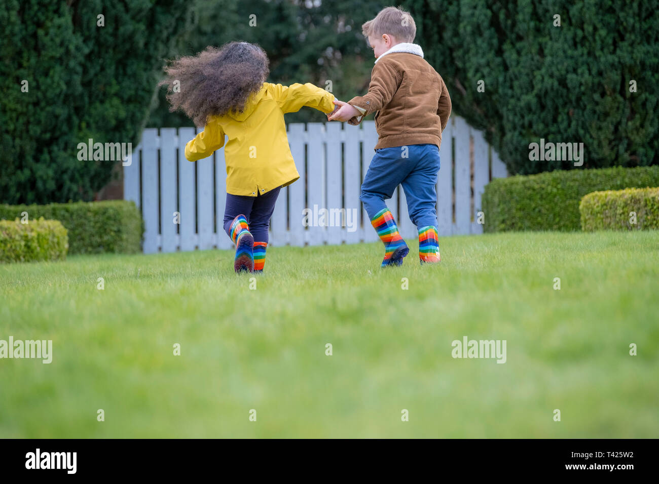 Children skipping enjoying playing outside Stock Photo