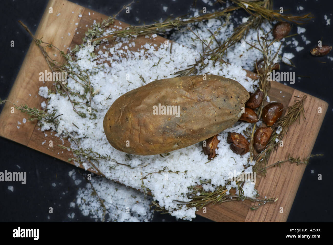 baked potato on rock salt Stock Photo Alamy