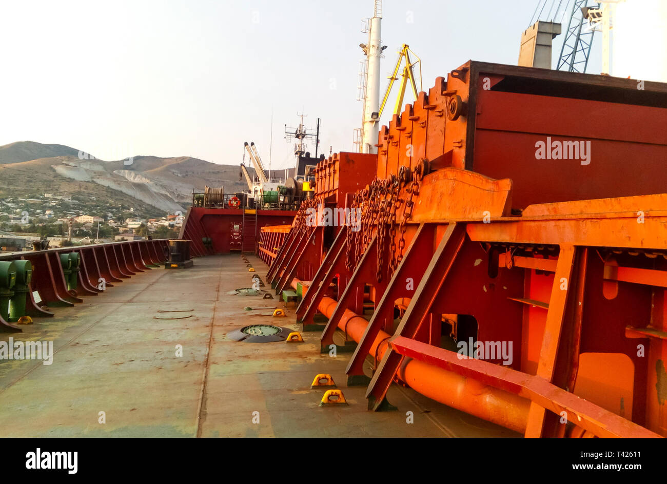 View of the sea and city beach from the port quay. Industrial port with ...