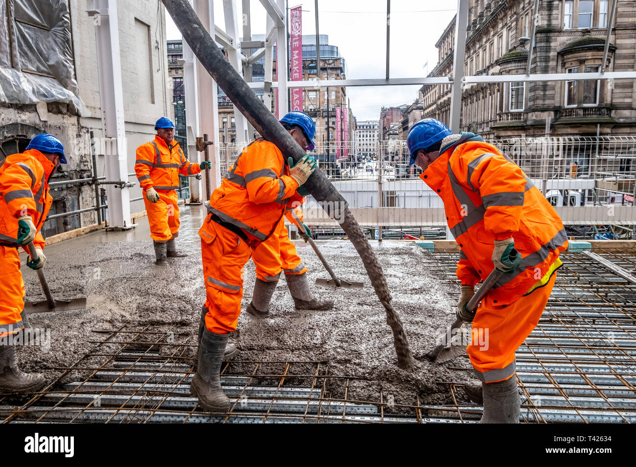 Concrete being poured for new train station platform Stock Photo