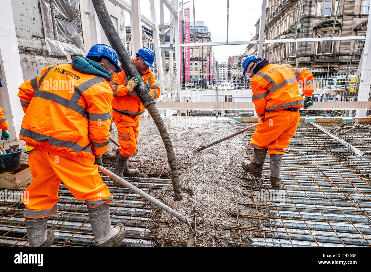 Concrete being poured for new train station platform Stock Photo