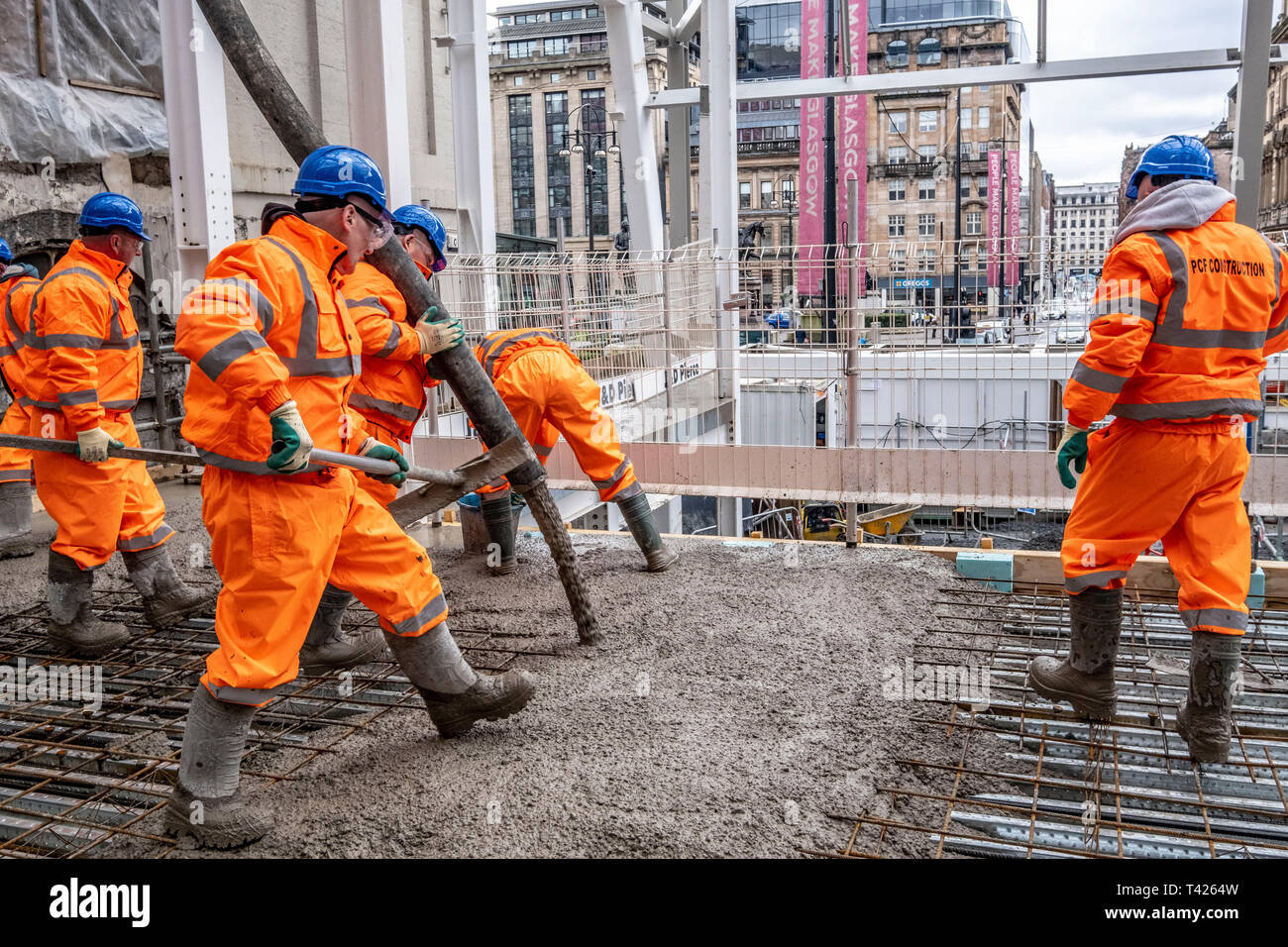 Concrete being poured for new train station platform Stock Photo