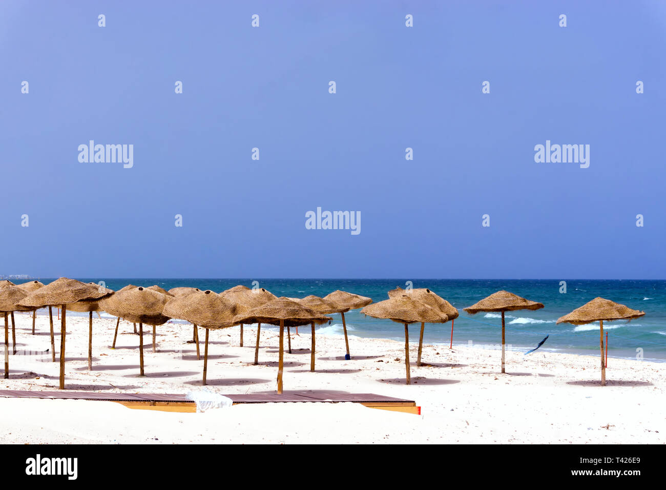 Landscape of empty beach covered with umbrellas in Sousse, Tunisia. Stock Photo