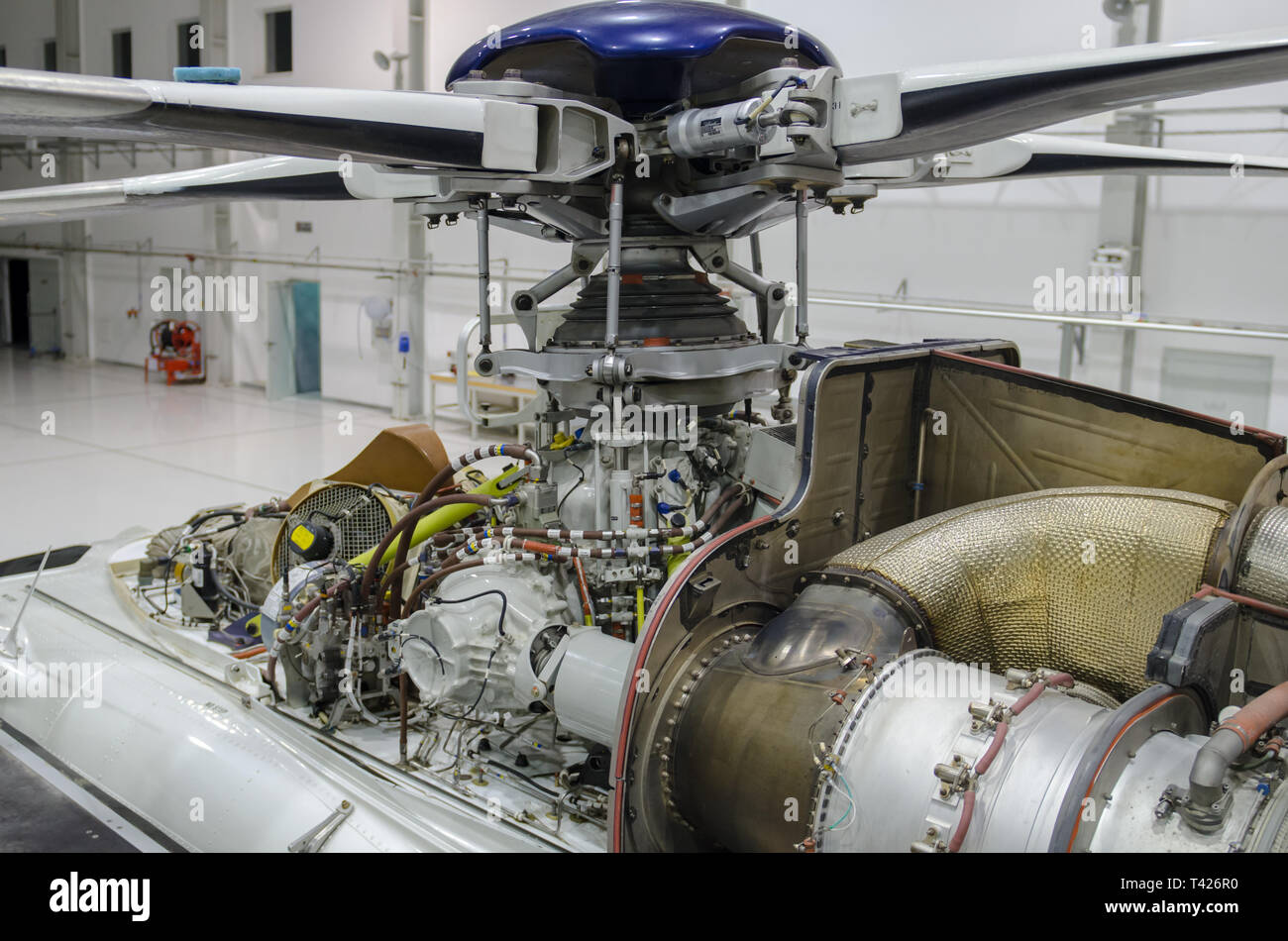 Helicopter gas-turbine engine with the cowling opened for maintenance in hangar Stock Photo