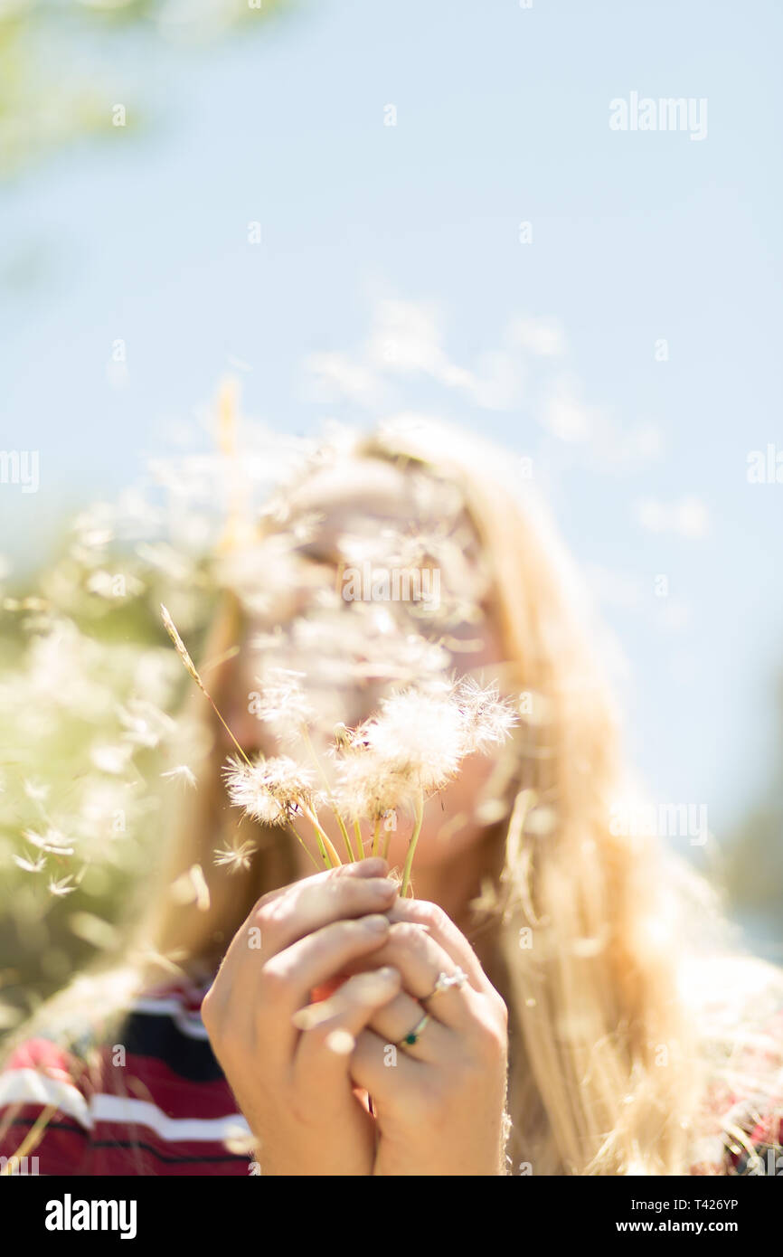 Girl blowing wish flower Stock Photo